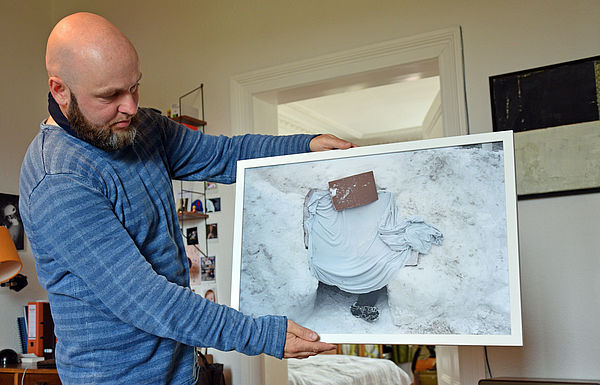 Heiko Krause hält eines seiner Bilder in den Händen.