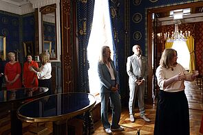 Rundgang durch das Schloss. Eine Frau erklärt, was alles neu ist.
