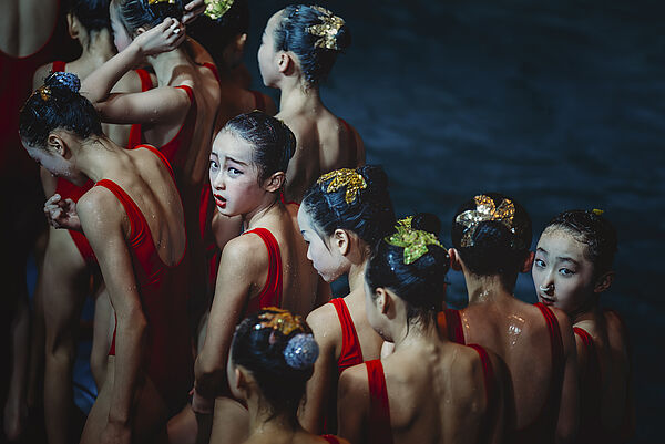 Die Fotografie zeigt Mädchen in roten Sportanzügen.