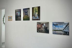 An der Wand hängen mehrere Fotos.