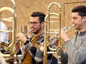 Zwei Musiker proben mit der Trompete.