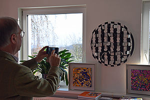 Ein Mitglied der Kunstkommission fotografiert Kunstwerke von Anka Kröhnke.