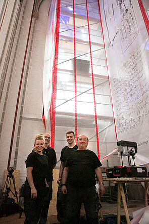 Eine Frau und drei Männer auf einem Gruppenfoto.