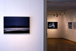 Blick in die Ausstellung. Bilder hängen im hinteren Zimmer.